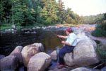 Fran Betters casts a line into the Ausable River, a fabled Adirondack trout stream near his shop, no date.