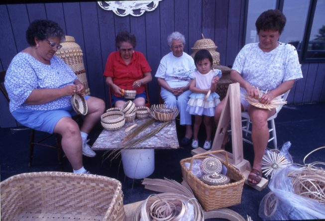 Akwesasne Mohawk ash splint and sweetgrass basket makers, 1994. Younger generations of basket makers continue to learn from more experienced basket makers in the community, often growing up around elders who practice the art.