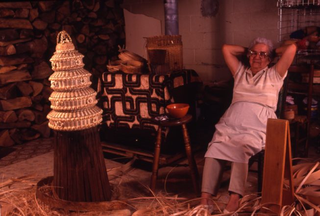 Mary Adams in her home basement workshop at Akwesasne, after completing a four-tiered ash splint and sweetgrass Wedding Cake Basket, 1992.