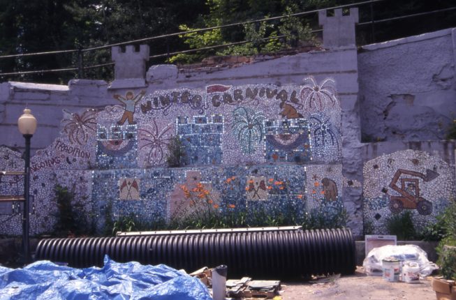 Mosaic mural in Saranac Lake celebrating the ongoing tradition of the Winter Carnival, including construction of the ice palace and related traditions, 1997.