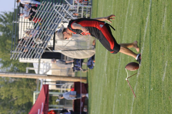 Red and Black kicker practicing before a game, 2012.